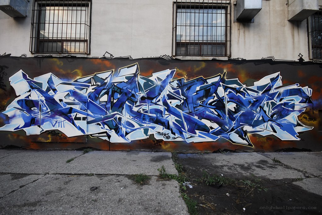blue and white graffiti on wall