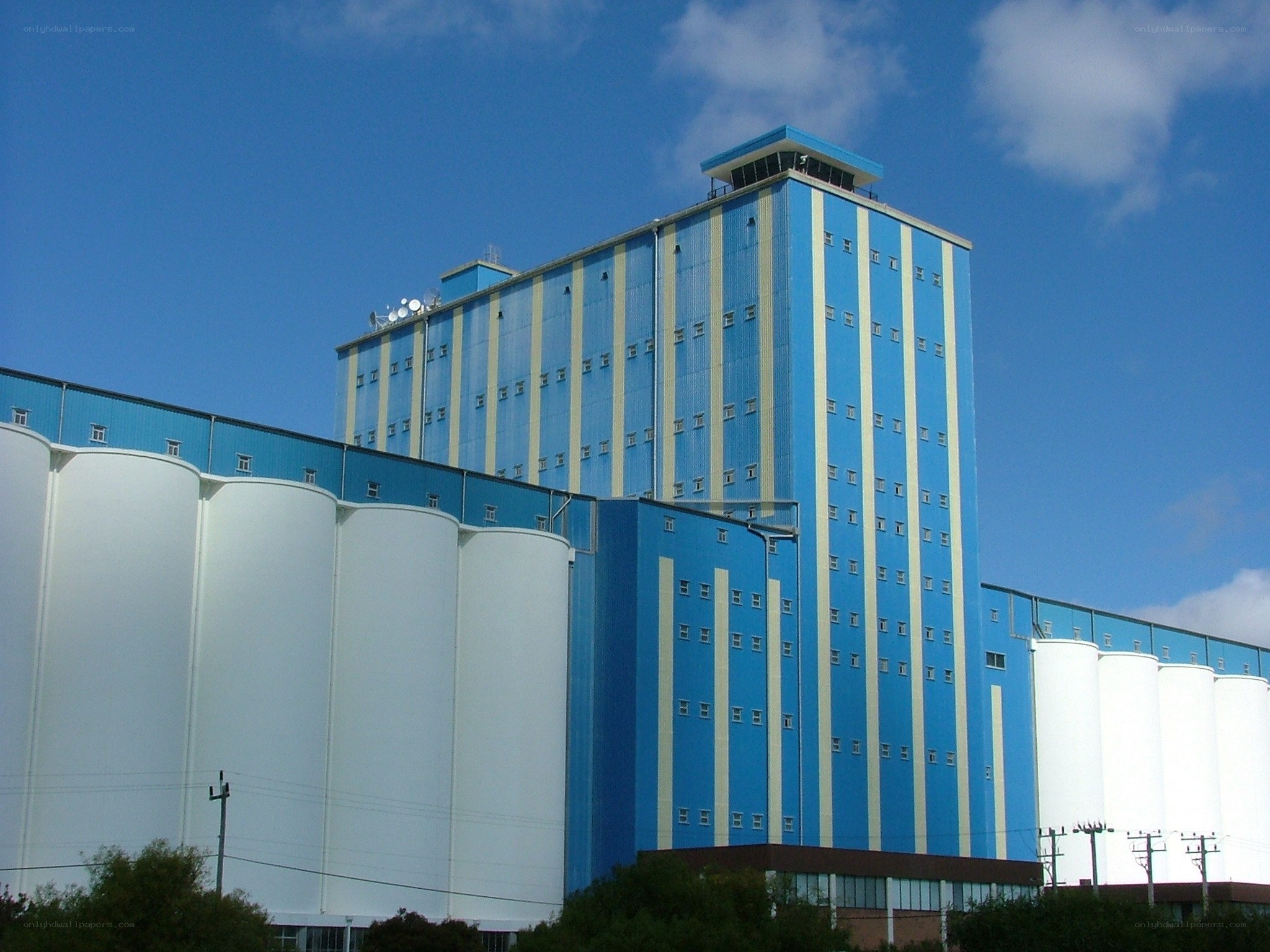 Blue and white industrial silos