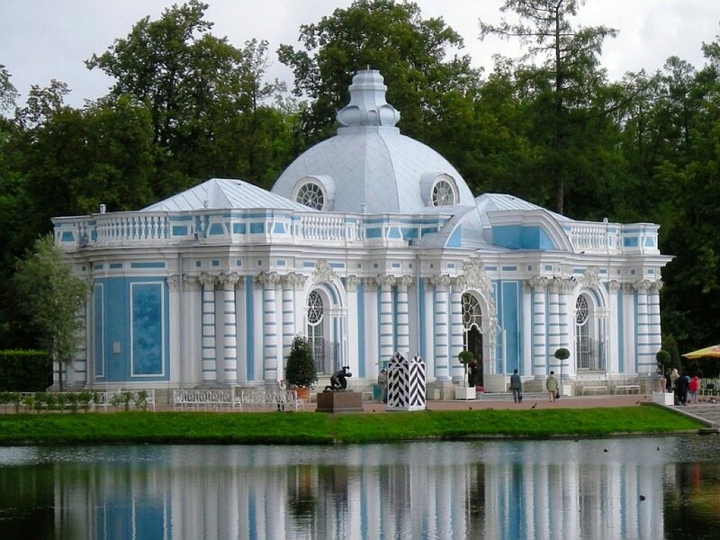 Blue and white pavilion by a lake
