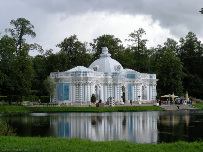 blue and white pavilion by a pond