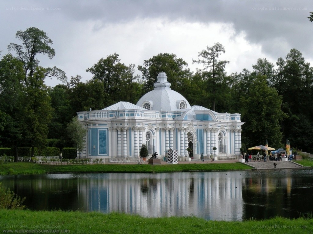 blue and white pavilion by lake