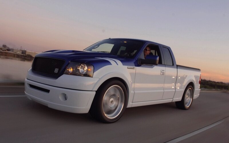 blue and white pickup truck driving