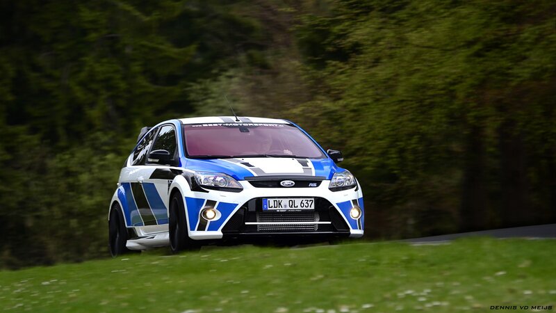 blue and white rally car on road