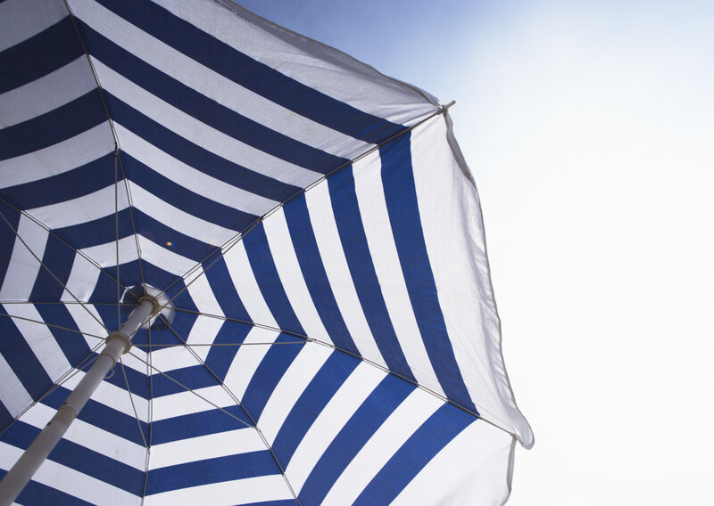 blue and white striped beach umbrella