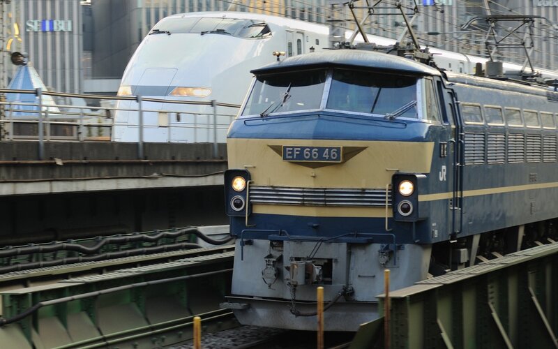 Blue and white trains on tracks