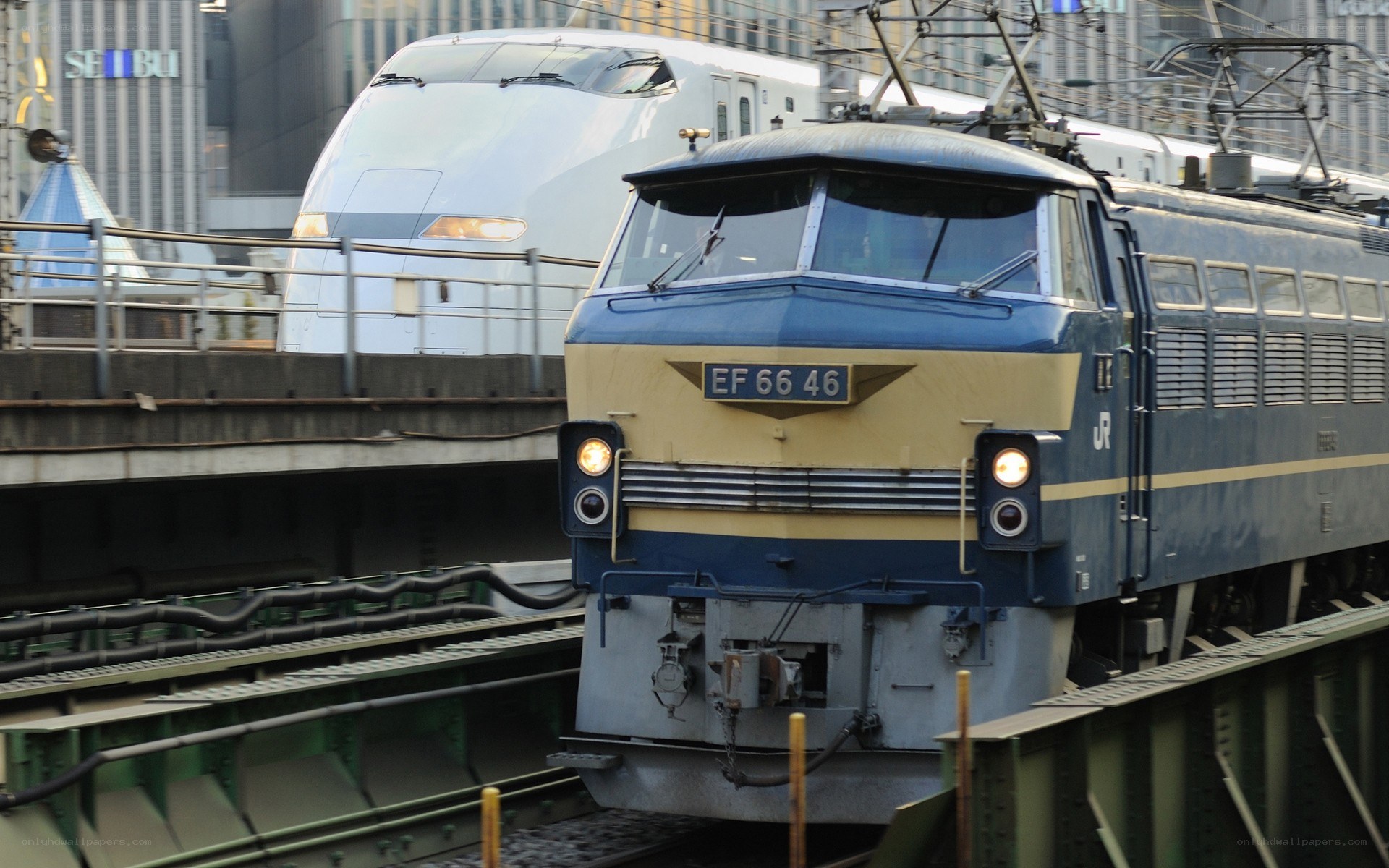 Blue and white trains on tracks