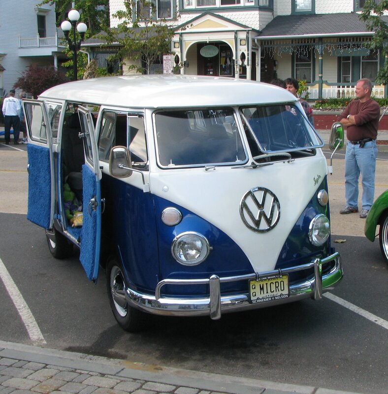 Blue and white VW bus at a car show