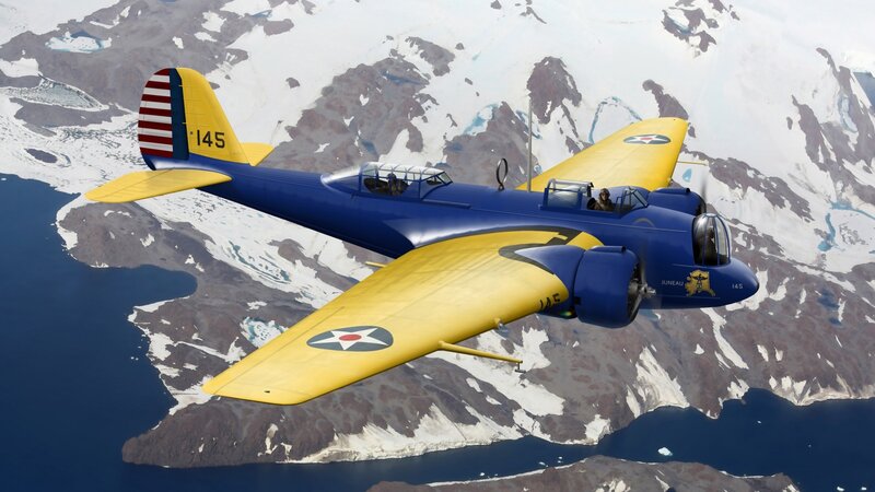 Blue and yellow aircraft flying over mountains