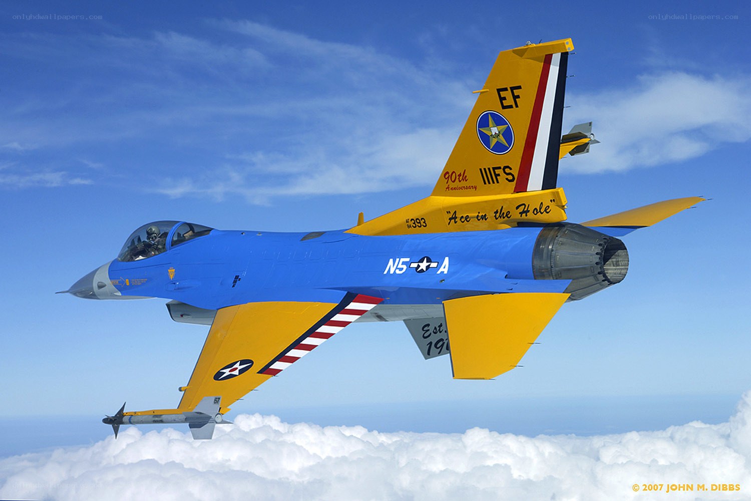 Blue and yellow fighter jet in flight