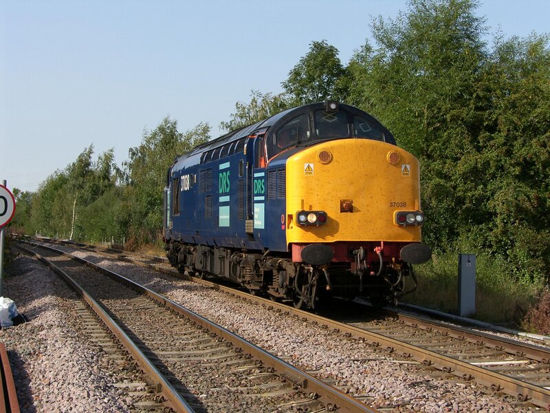 Blue and yellow locomotive on tracks