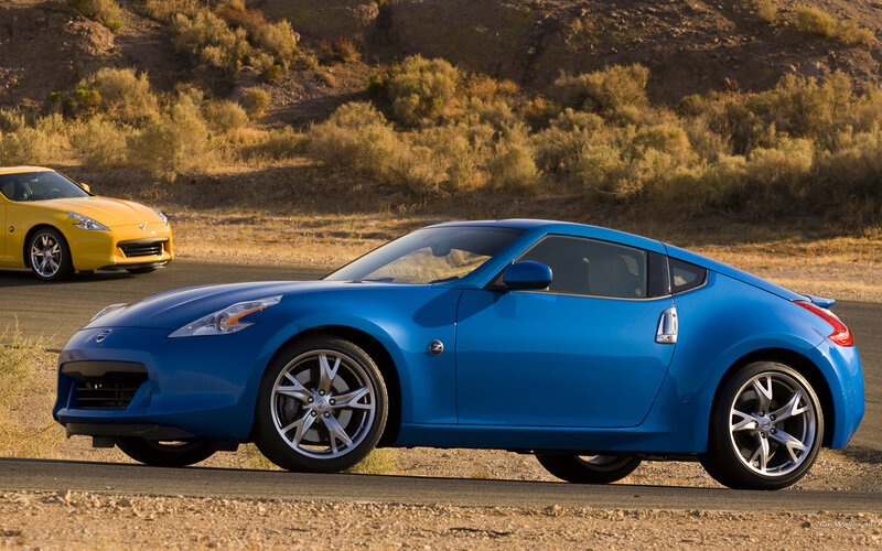Blue and yellow sports cars on road