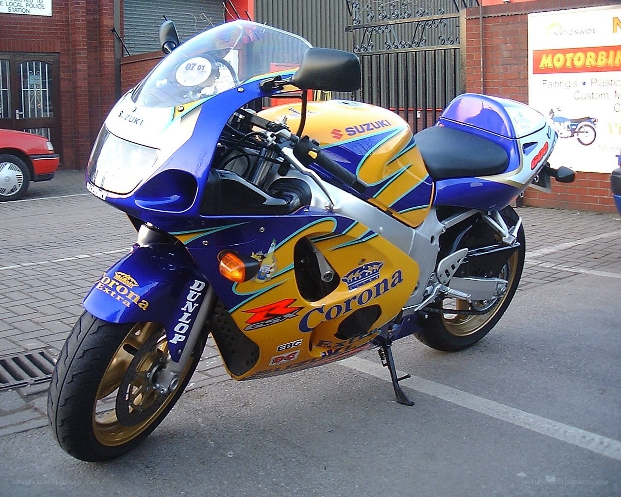 blue and yellow Suzuki motorcycle