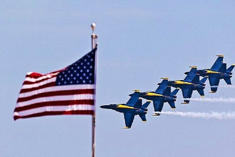Blue Angels fly past American flag