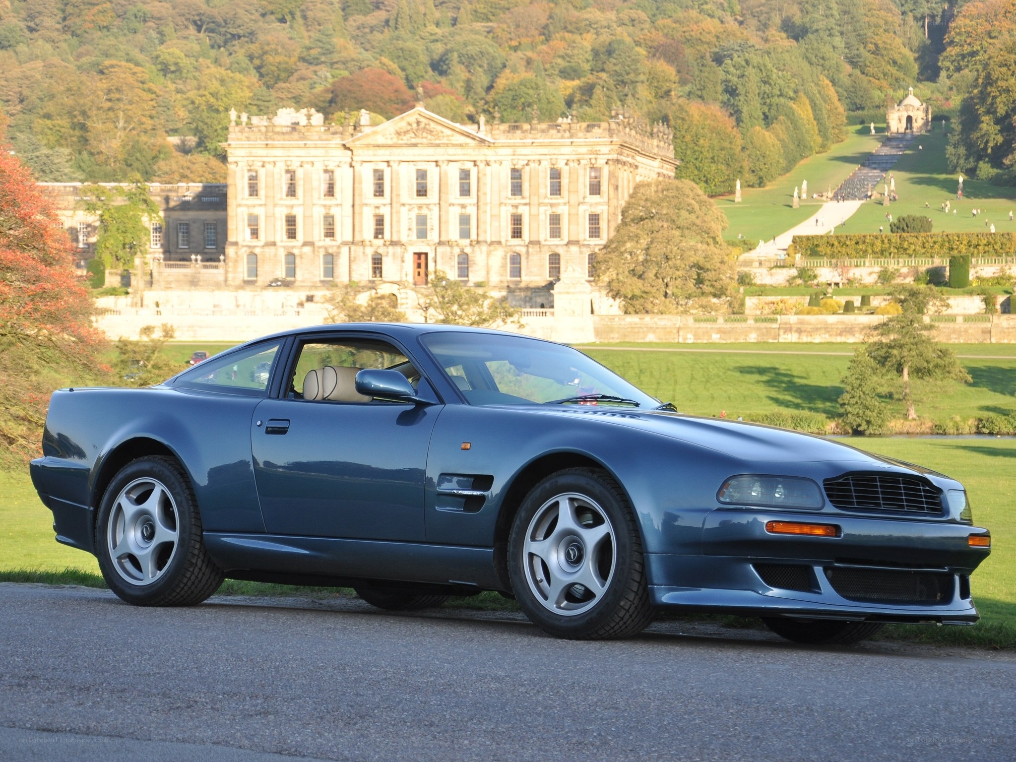 Blue Aston Martin at a stately home