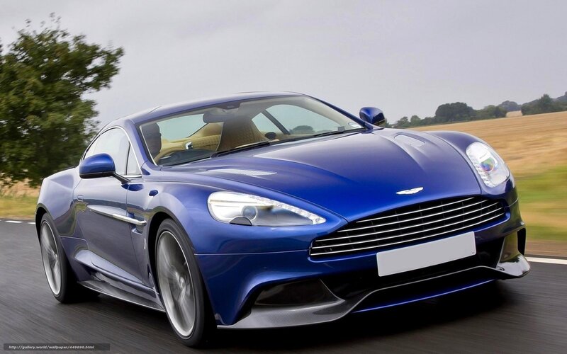 blue aston martin driving on road