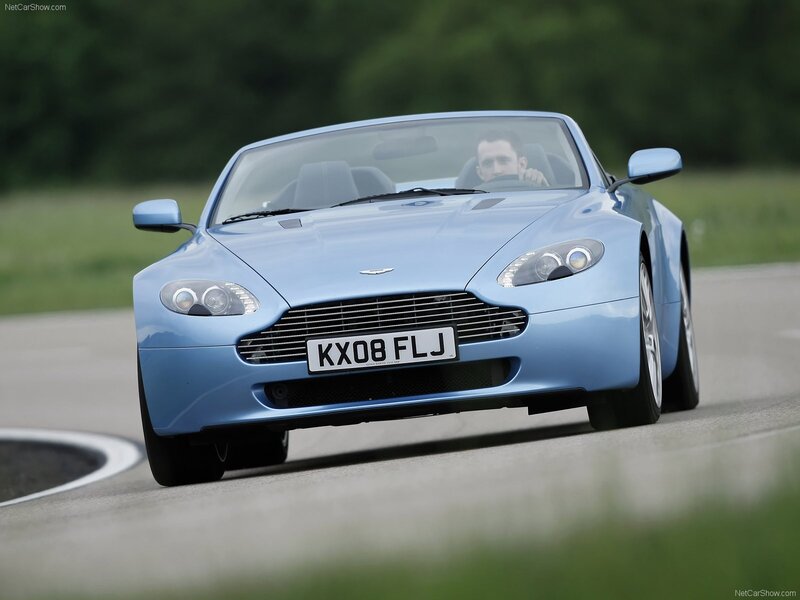blue aston martin driving