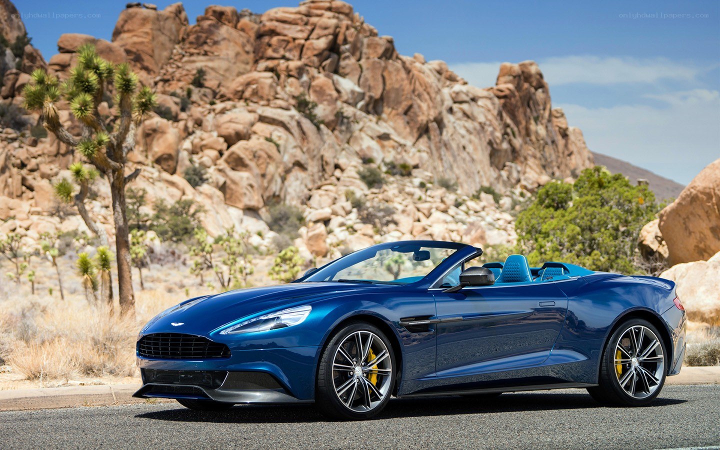 Blue Aston Martin in desert
