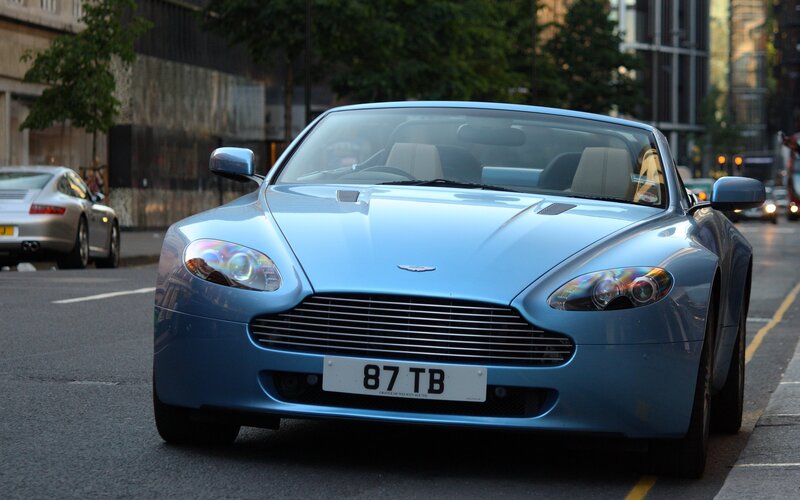Blue Aston Martin on city street