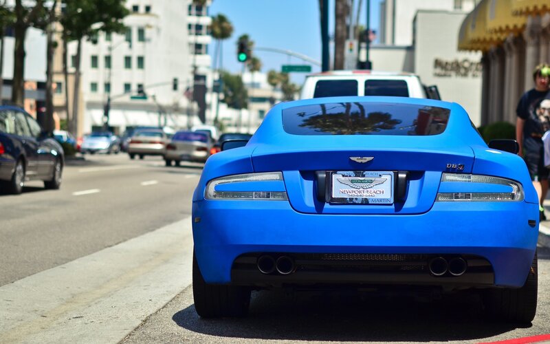 Blue Aston Martin on city street