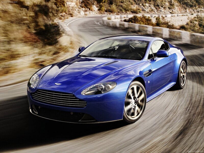 blue aston martin on winding road