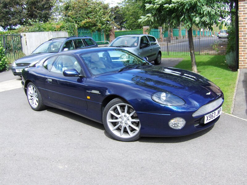 Blue Aston Martin parked in driveway