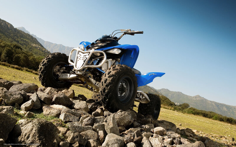 Blue ATV on rocky terrain
