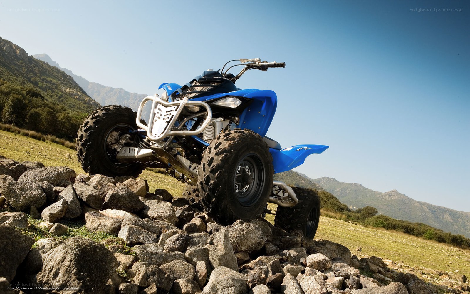 Blue ATV on rocky terrain