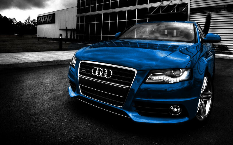 Blue Audi car in front of building