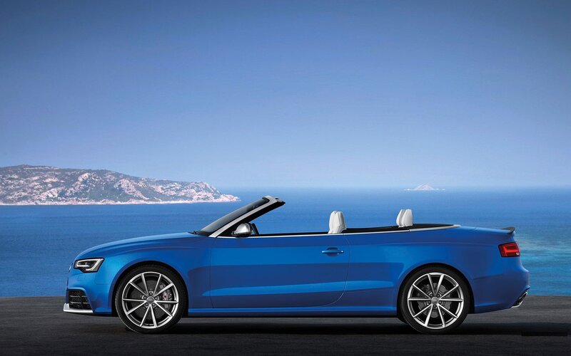 Blue Audi convertible by the sea