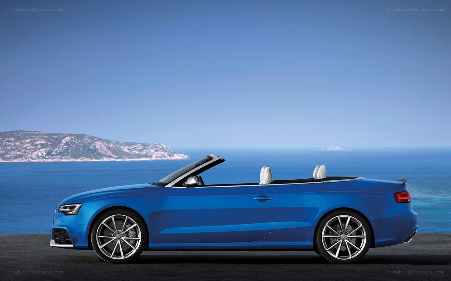 Blue Audi convertible by the sea