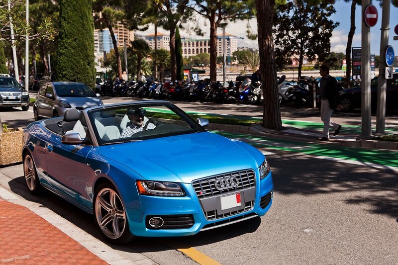 Blue Audi convertible on city street