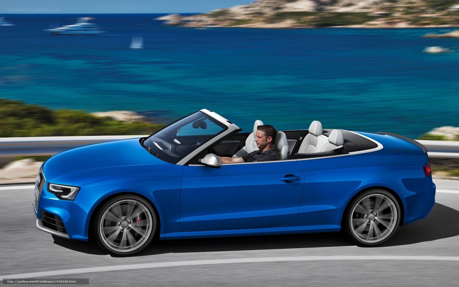 Blue Audi convertible on coastal road