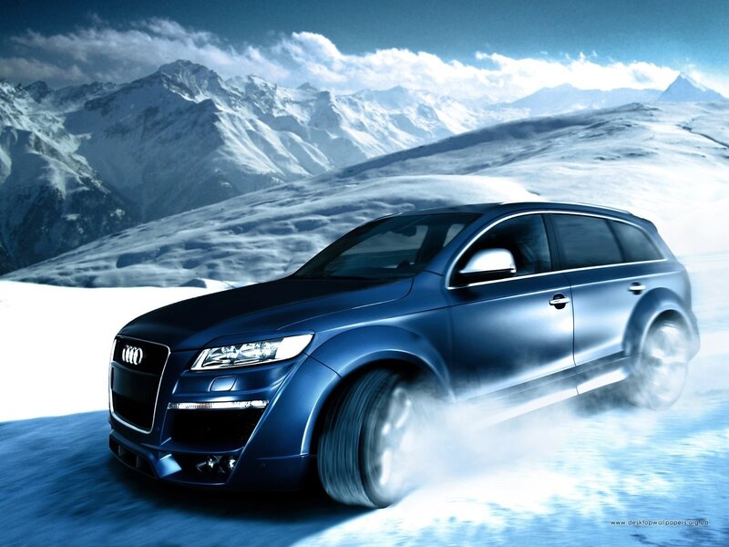 Blue Audi in snowy mountains