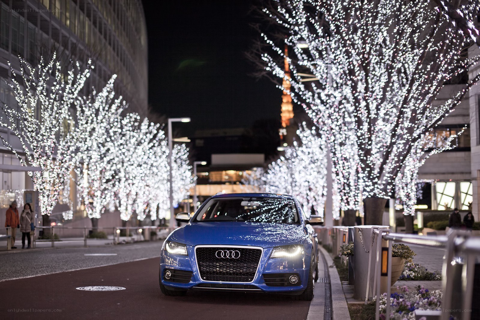 Blue Audi on a lit street