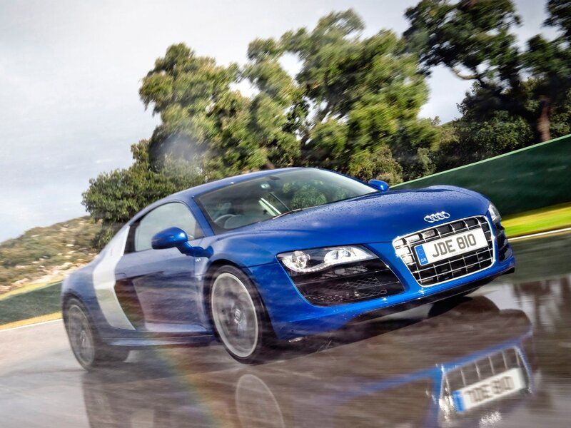 blue audi r8 on wet track