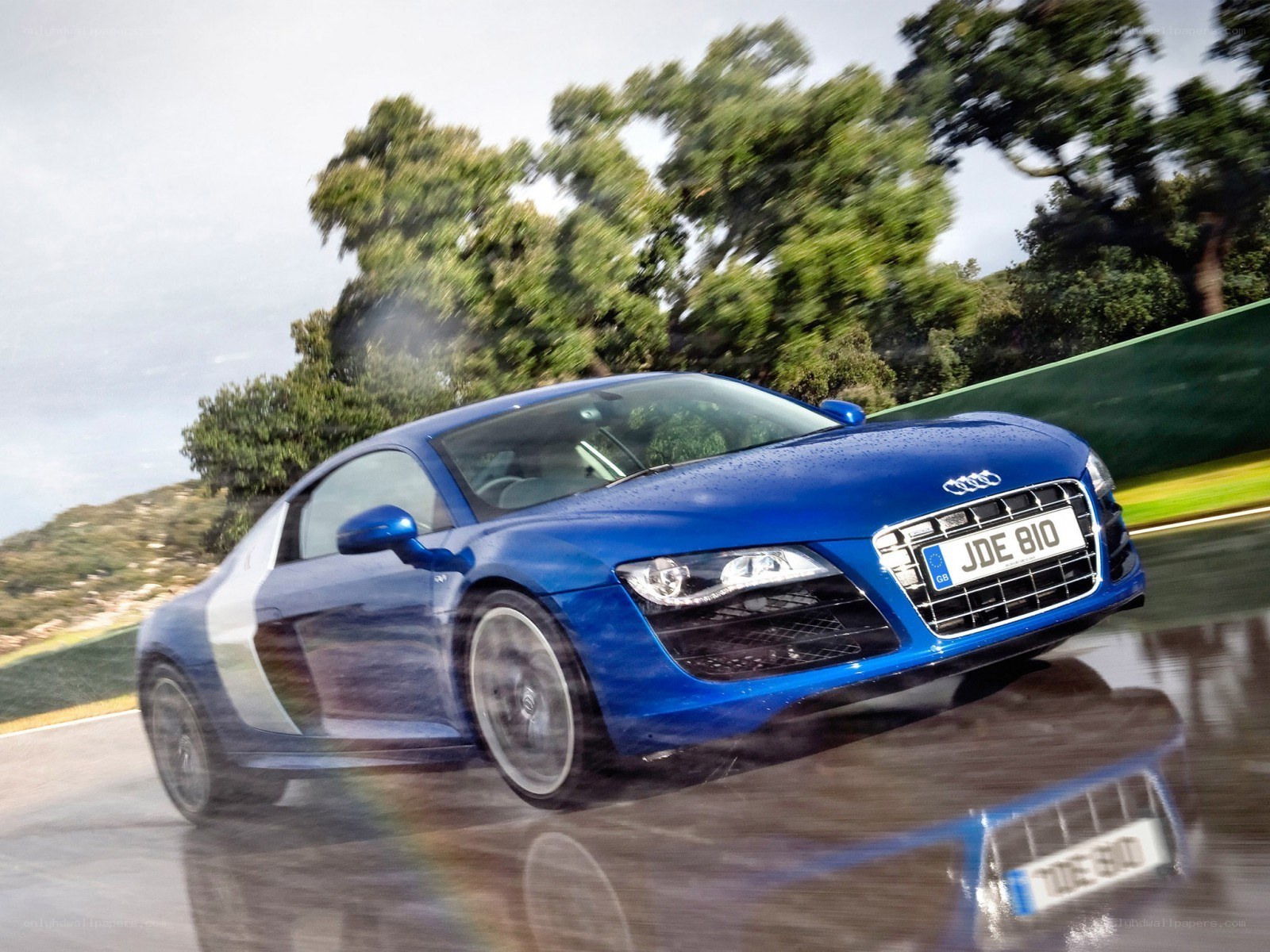 blue audi r8 on wet track