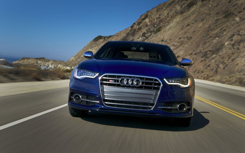 Blue Audi S6 on coastal road