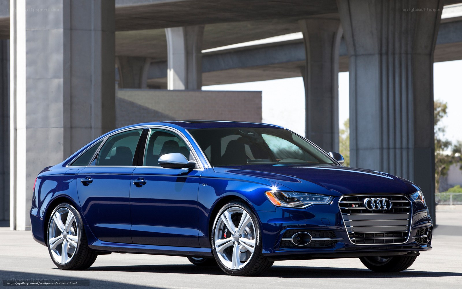 Blue Audi S6 sedan under overpass
