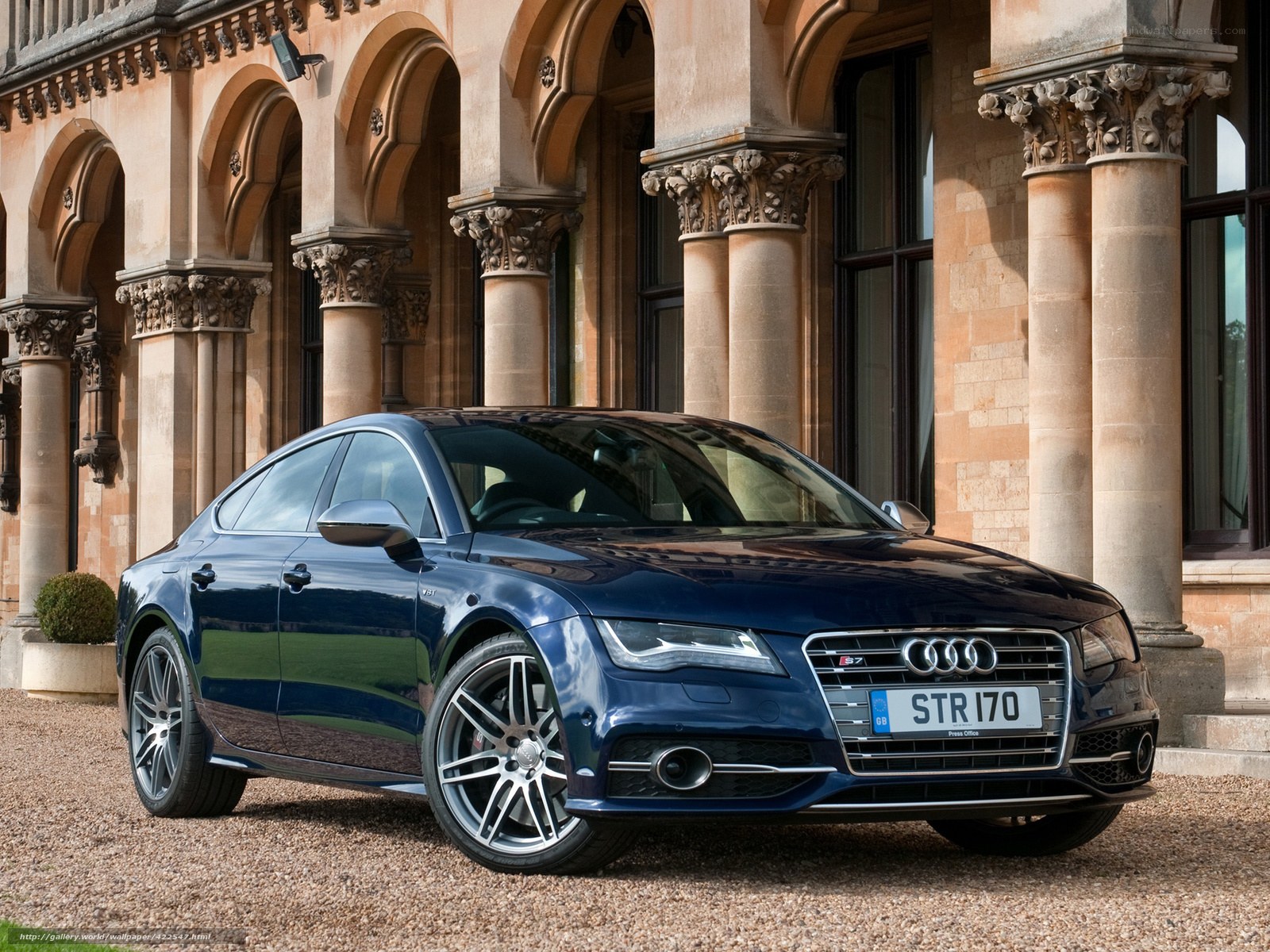 Blue Audi S7 parked in front of a building