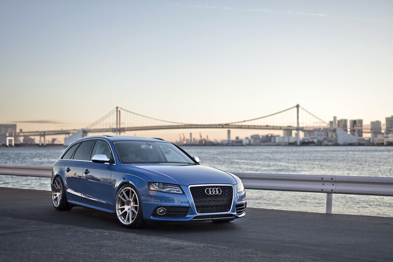 Blue Audi station wagon by the water