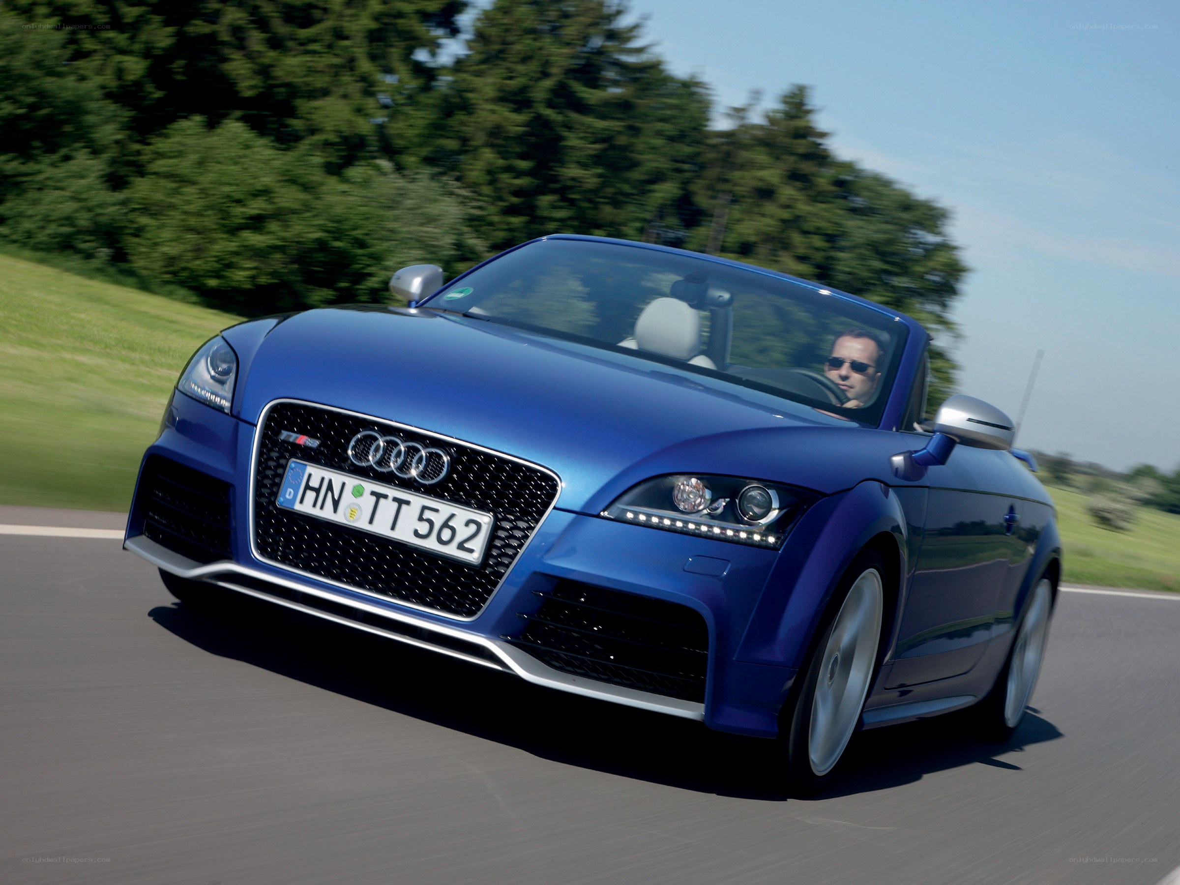 Blue Audi TT RS convertible driving