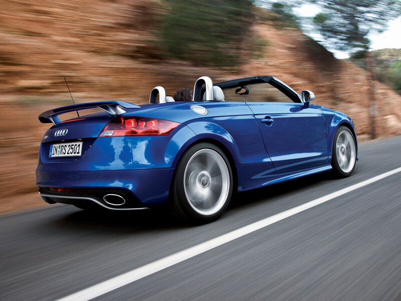 Blue Audi TT RS convertible in motion