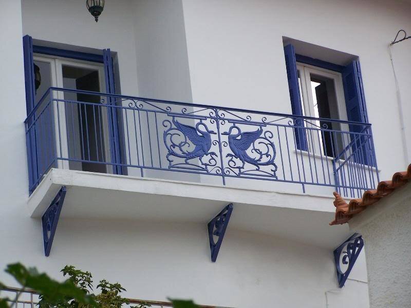 blue balcony with ornate railings