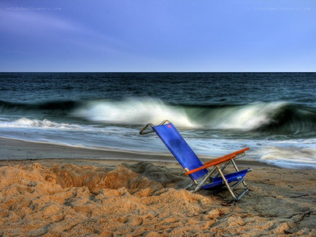 Blue beach chair on shore