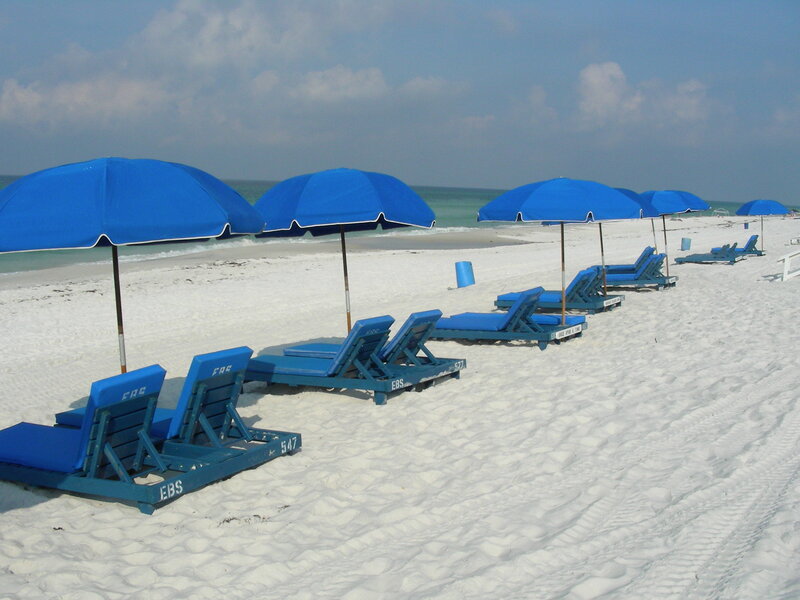 Blue beach umbrellas and lounge chairs