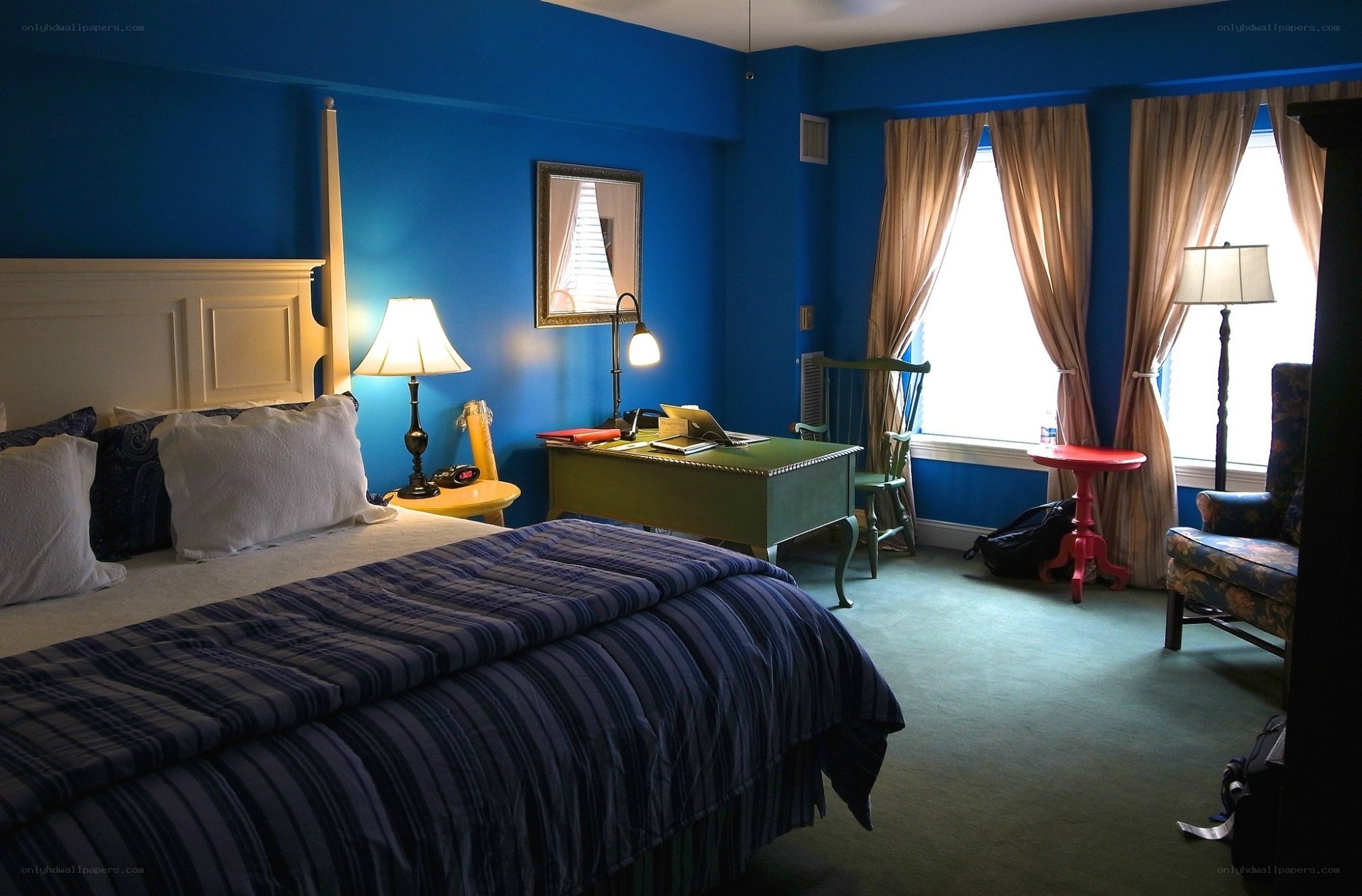 Blue bedroom with desk and window