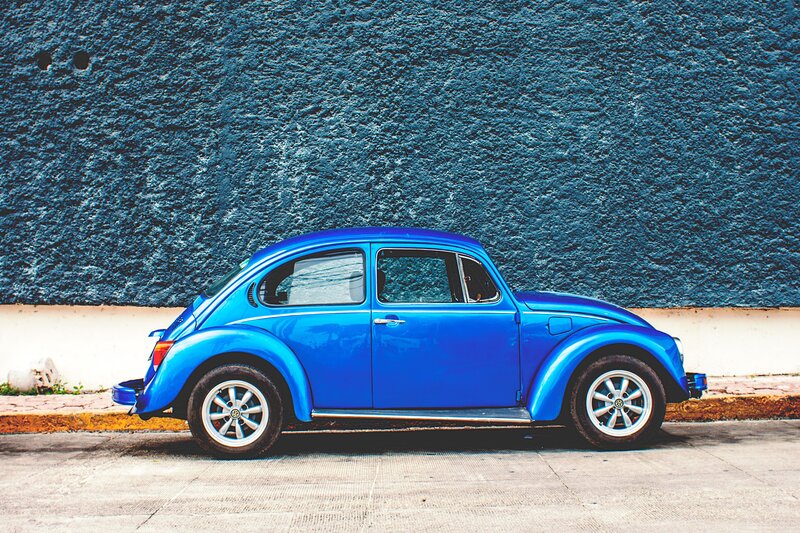 Blue Beetle car against blue wall