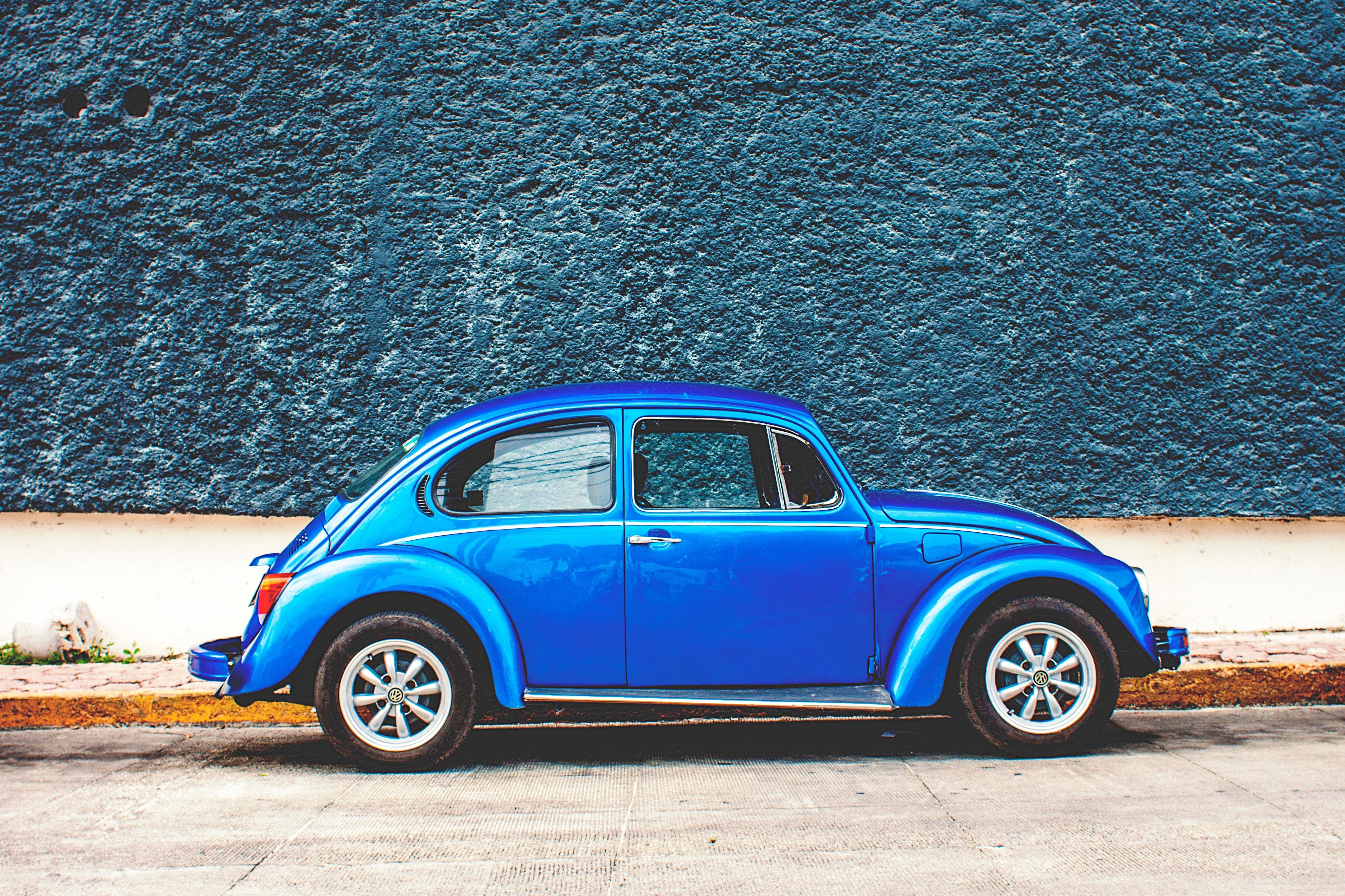 Blue Beetle car against blue wall