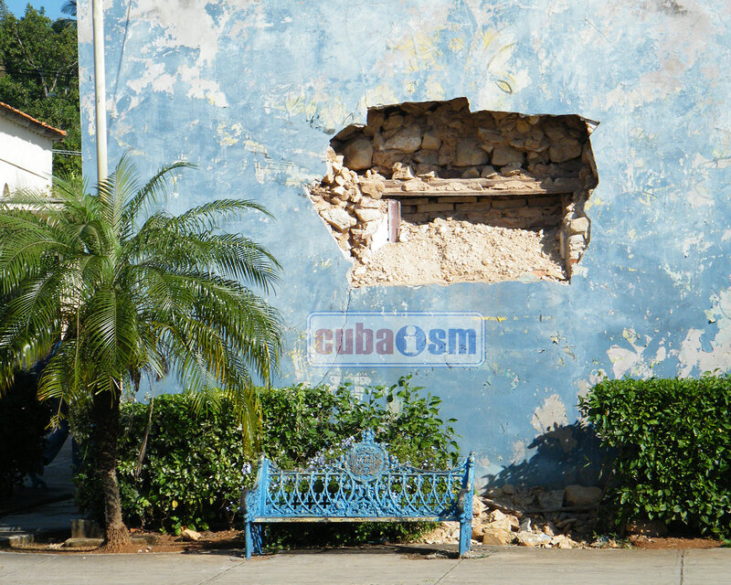 Blue bench with damaged wall