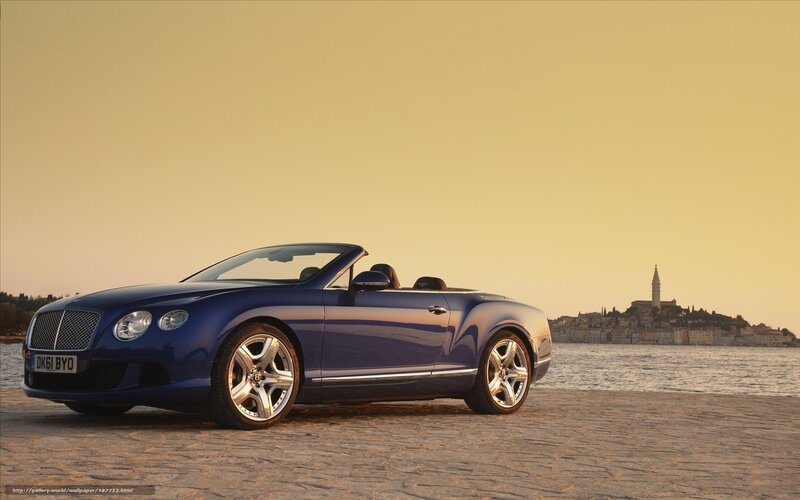 Blue Bentley convertible by the sea